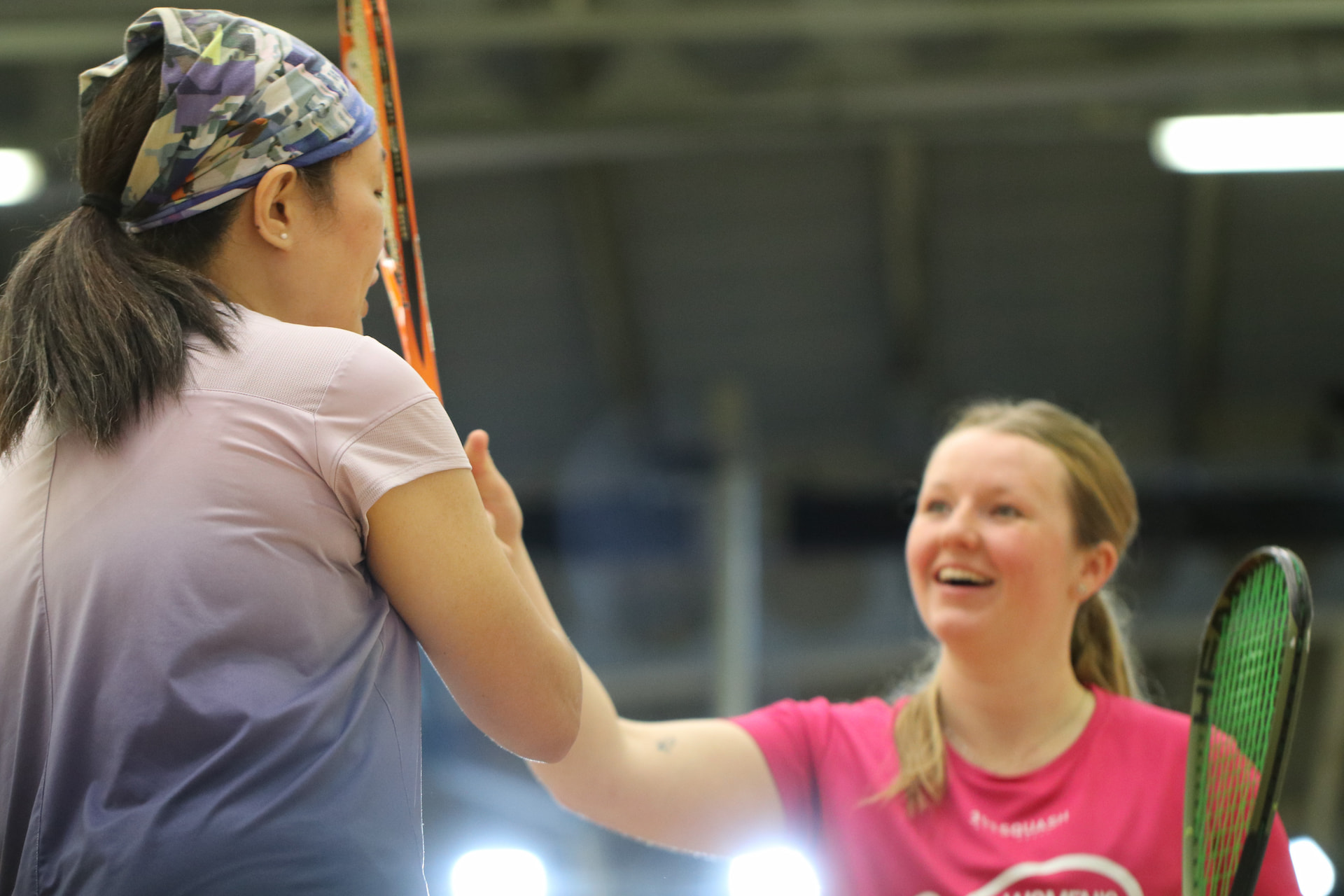 Players on a squash court during a racketball coaching session